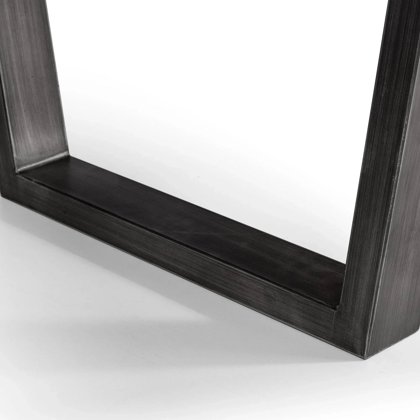 Black metal dining table leg detail on white floor