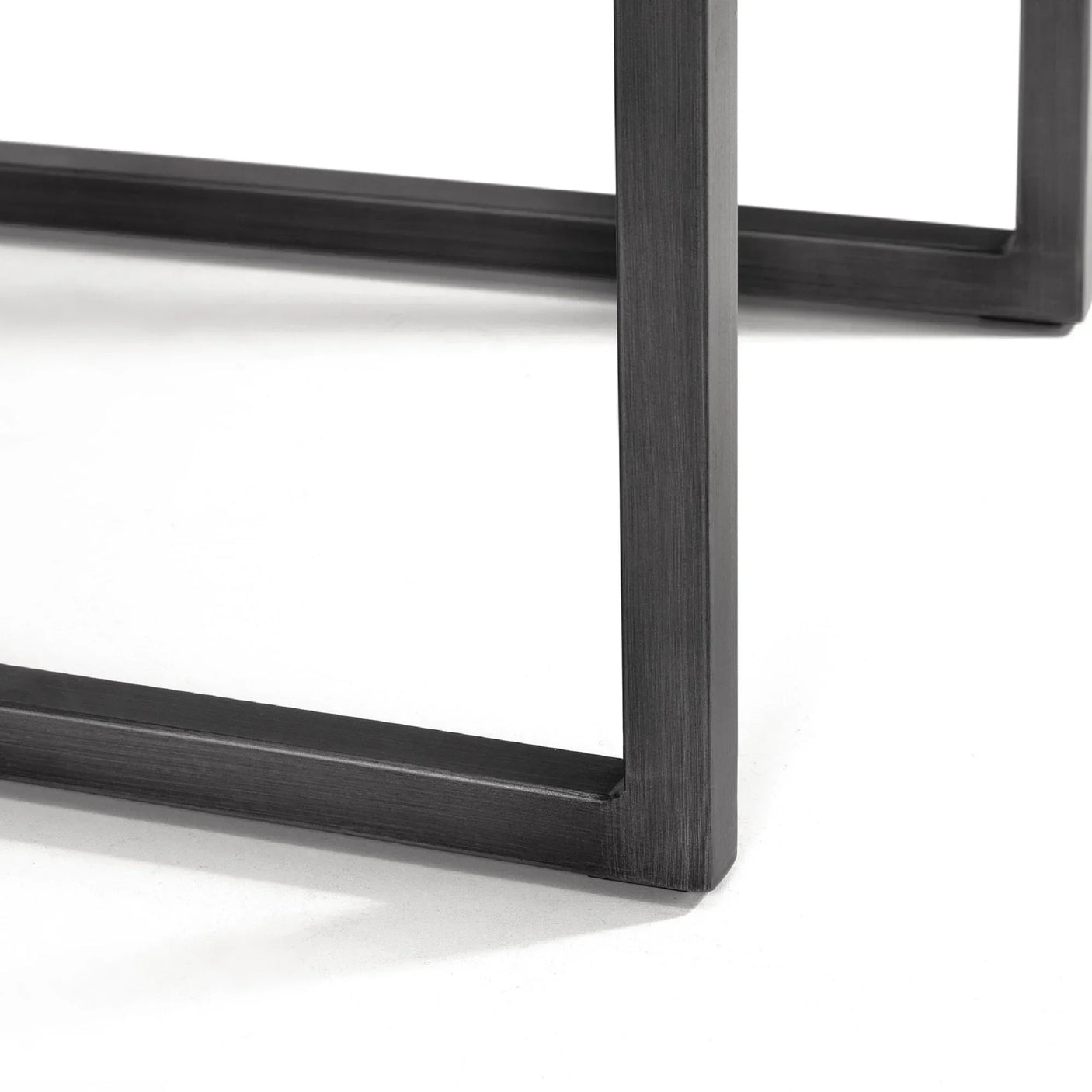 Close-up of Brooklyn dining chair brown metal frame leg on white background