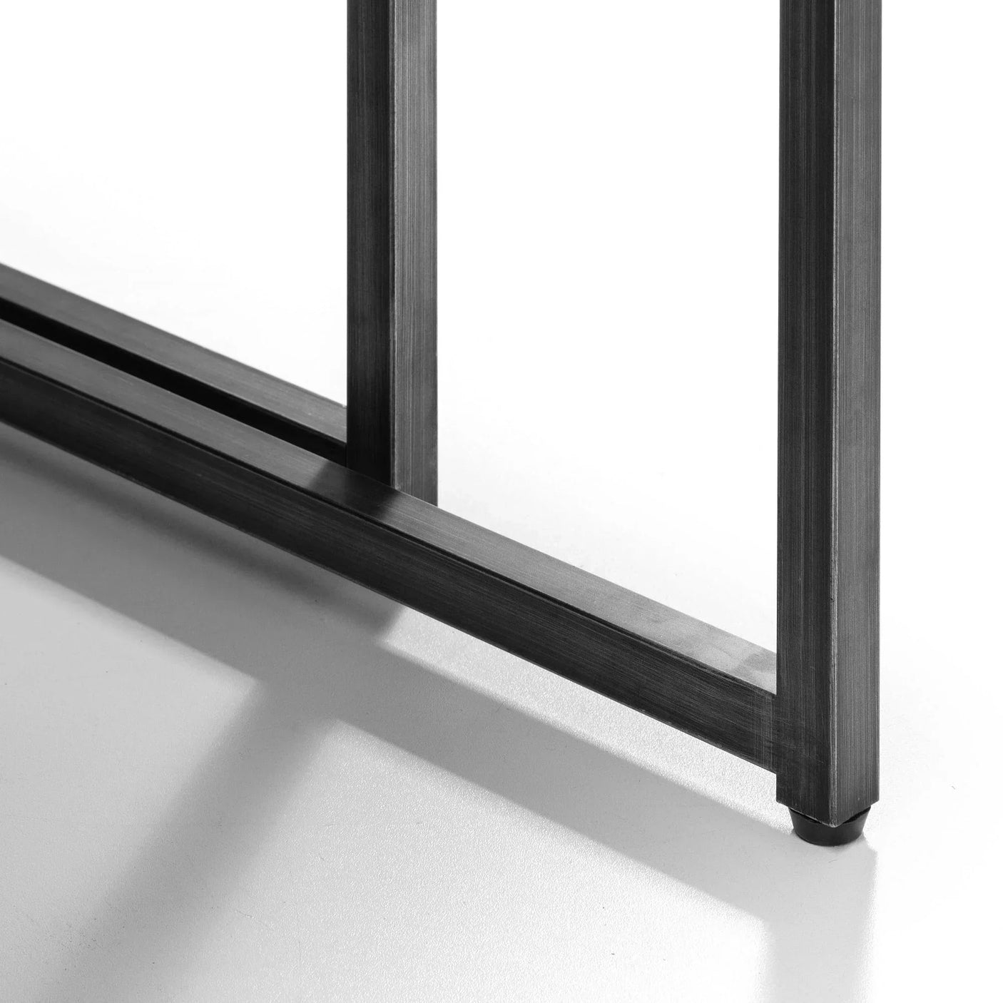 Black metal base detail of Brooklyn nesting coffee tables on white background