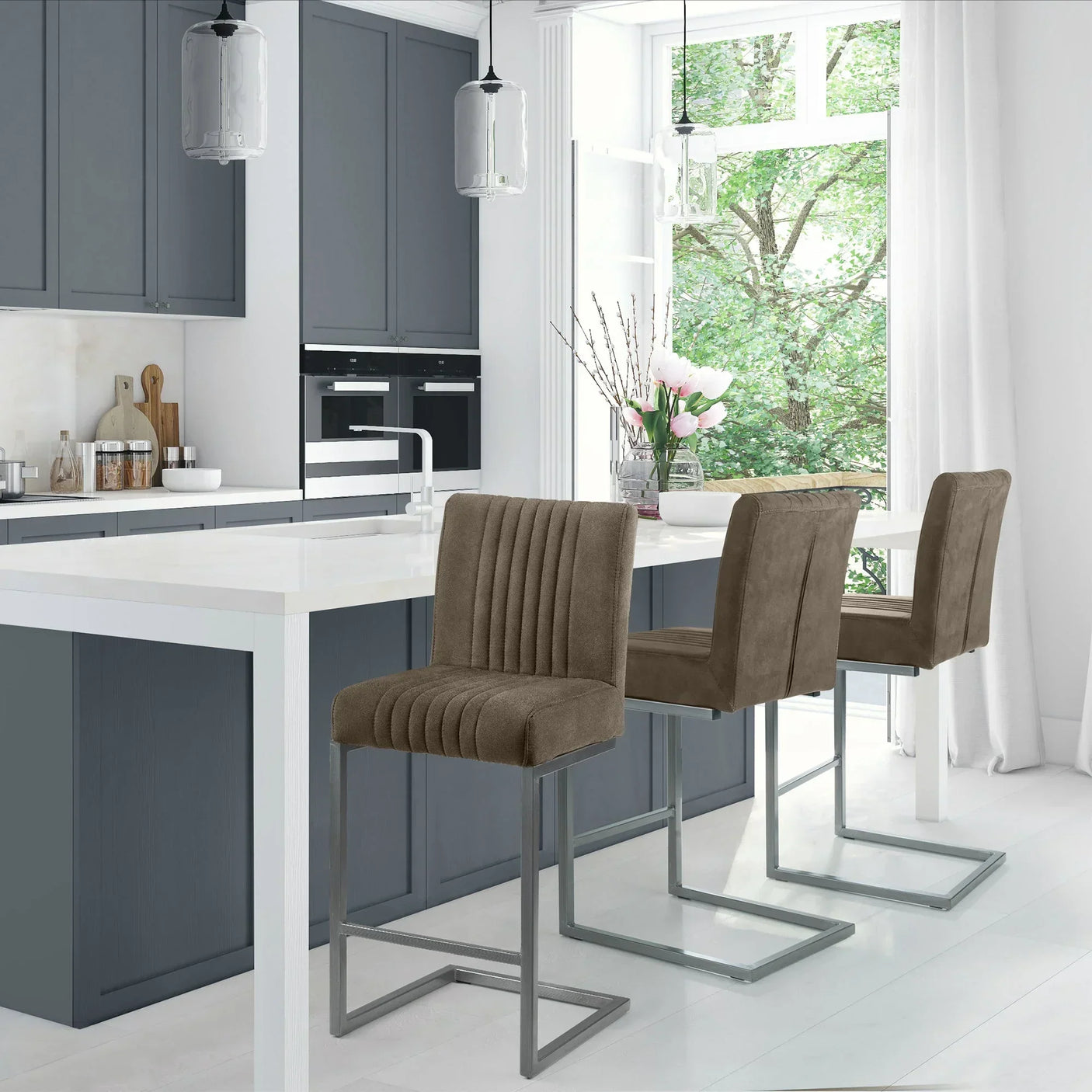 Charcoal grey bar stools with metal legs at white kitchen island with dark cabinets