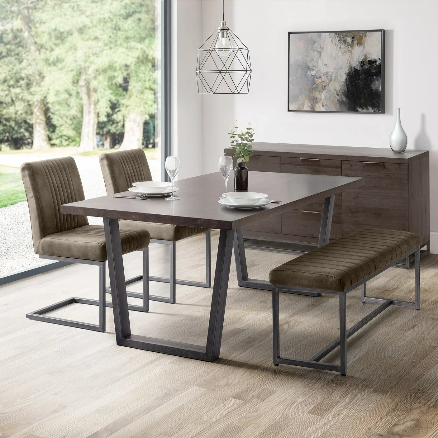 Charcoal grey dining chair with metal frame beside matching bench and table in modern room
