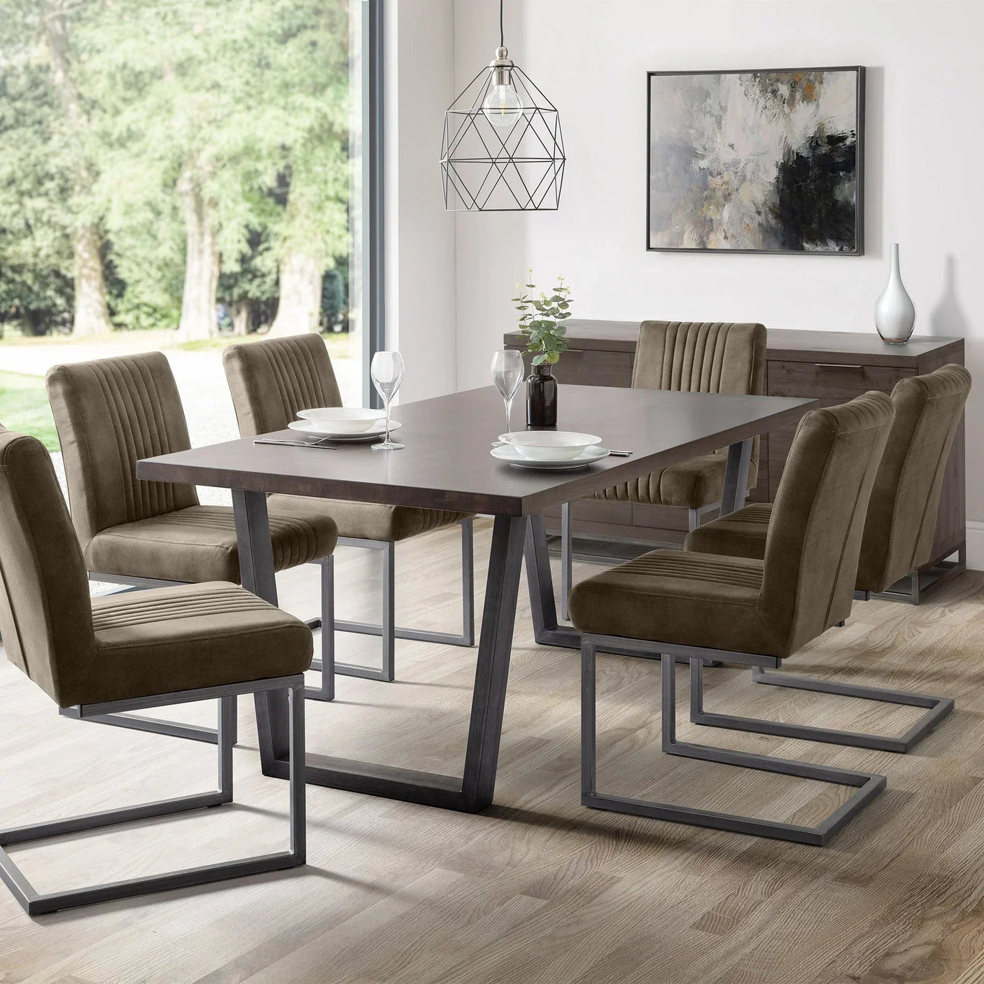 Charcoal grey Brooklyn dining chair set with metal legs around modern wood table in bright room
