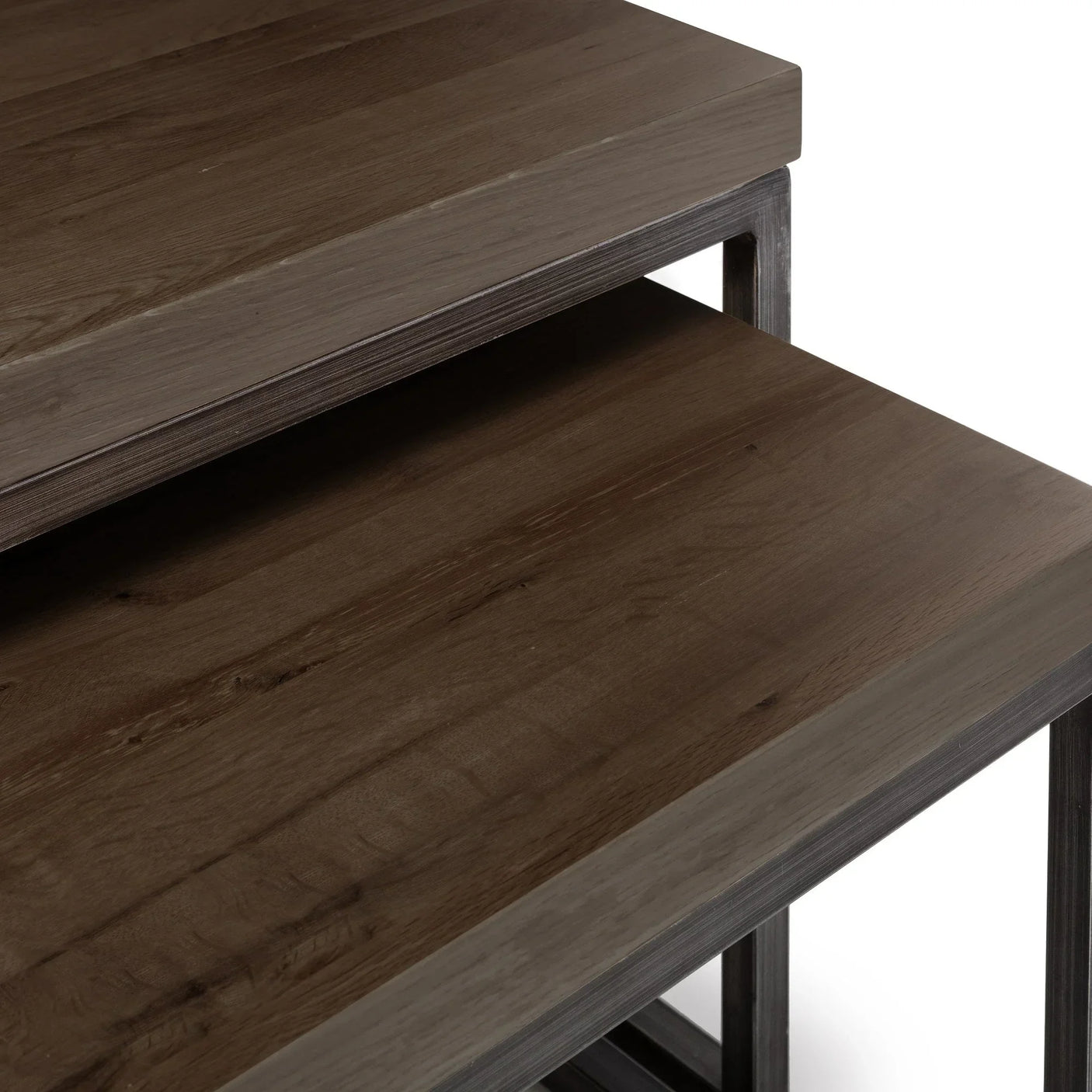 Dark oak nesting coffee tables with metal frame, closeup of wood grain and table edges