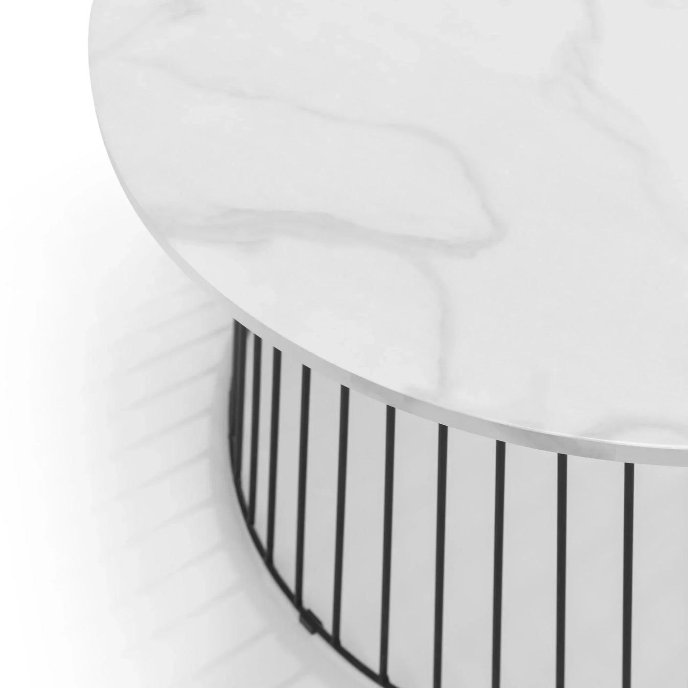 Round marble coffee table with black metal base, close view of tabletop and frame detail