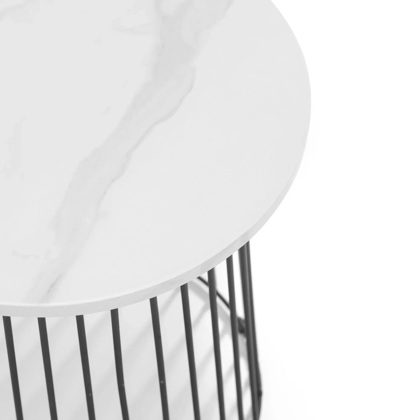 Round marble effect side table with black metal base, close-up of top surface