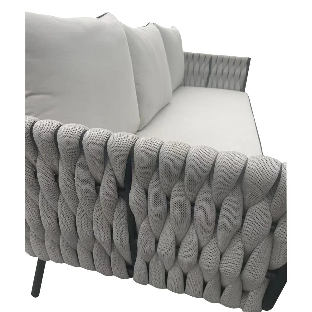 Grey woven rope sofa with plush seat and back cushions, angled armrest and modern design