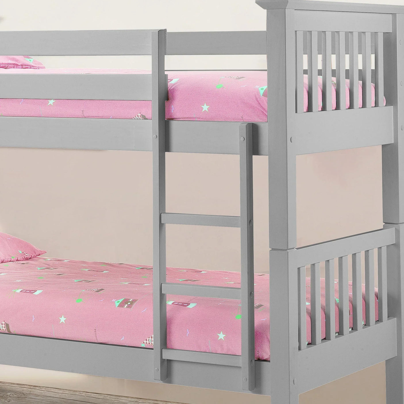 Dove grey bunk bed with vertical ladder and slatted safety rails, shown with pink bedding