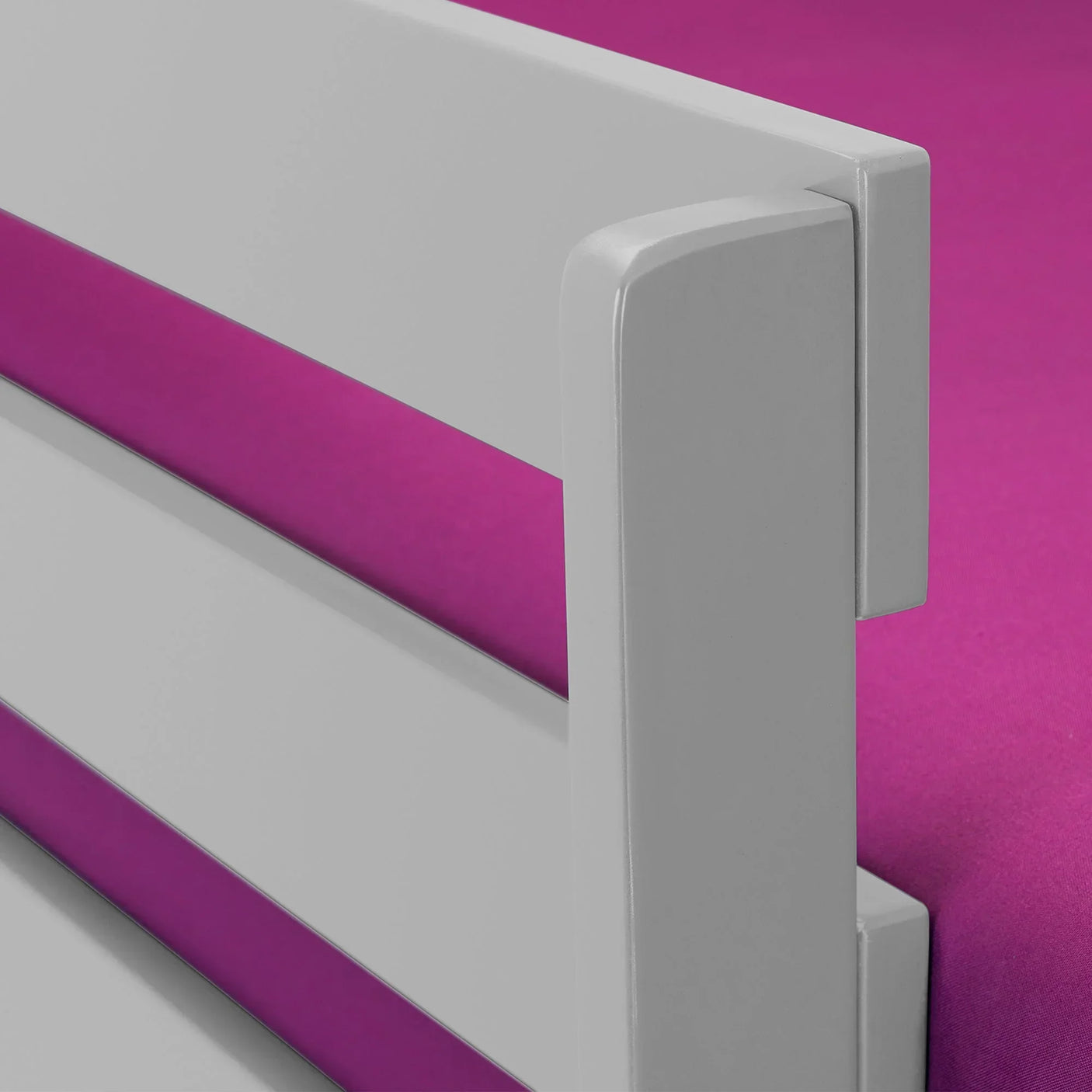 Dove grey bunk bed side rail detail against pink mattress background