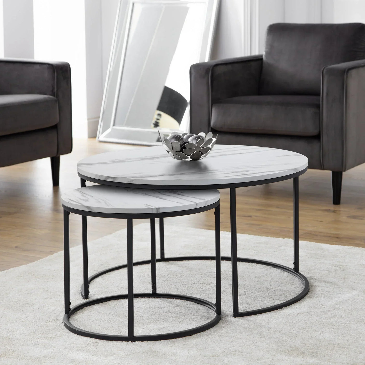 White marble nest of coffee tables with black metal frames in modern living room
