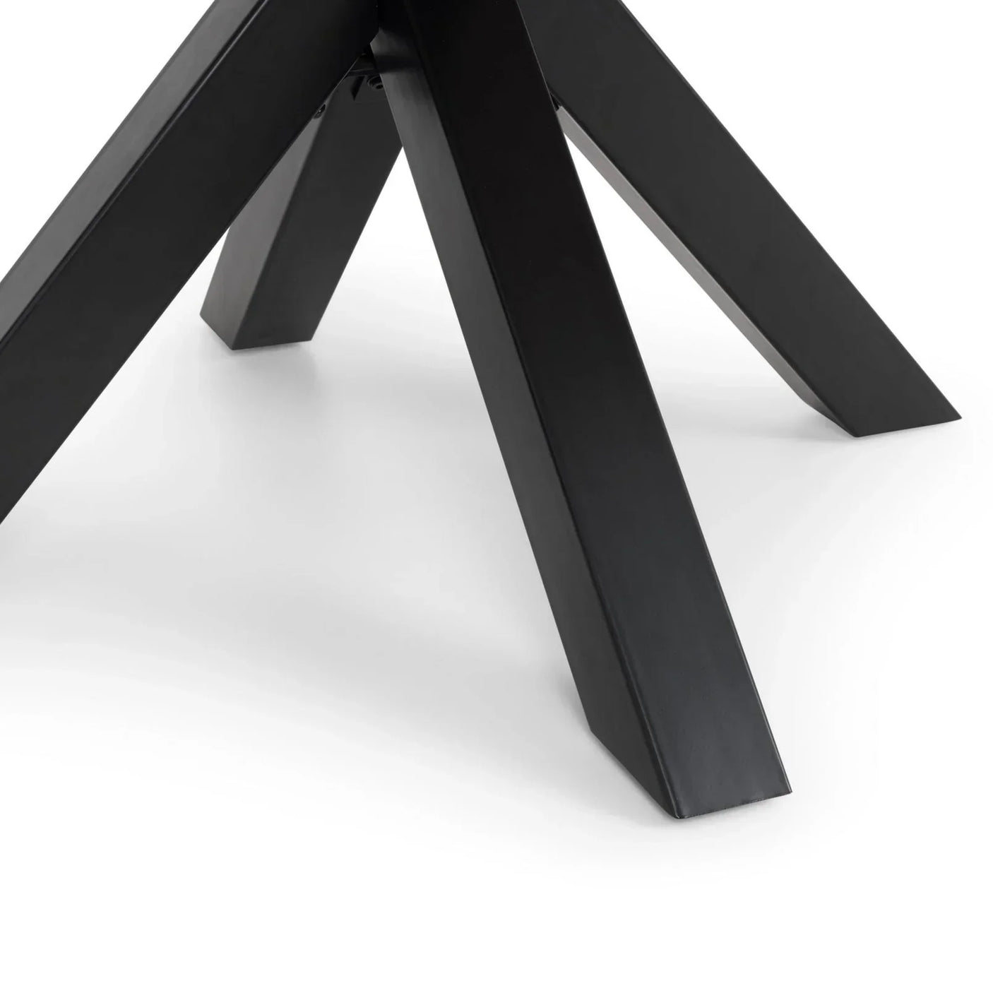 Black metal dining table legs detail against white background