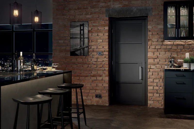Black chelsea internal door with modern panel design in brick wall kitchen setting