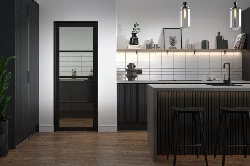 Black Chelsea Glazed 4L clear internal door in modern kitchen with wood flooring