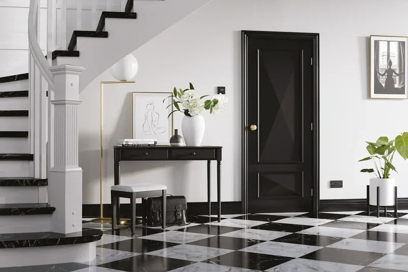 Black interior door with gold handle in modern hallway, checkerboard floor, black console table