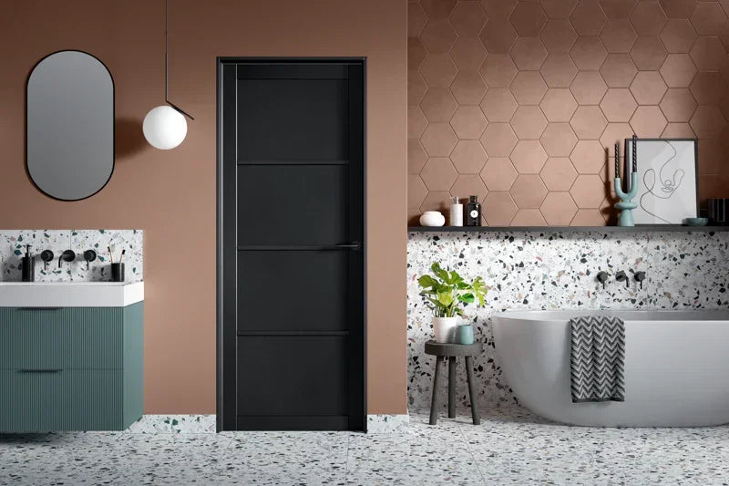 Black interior door in modern bathroom with terrazzo floor and freestanding bath
