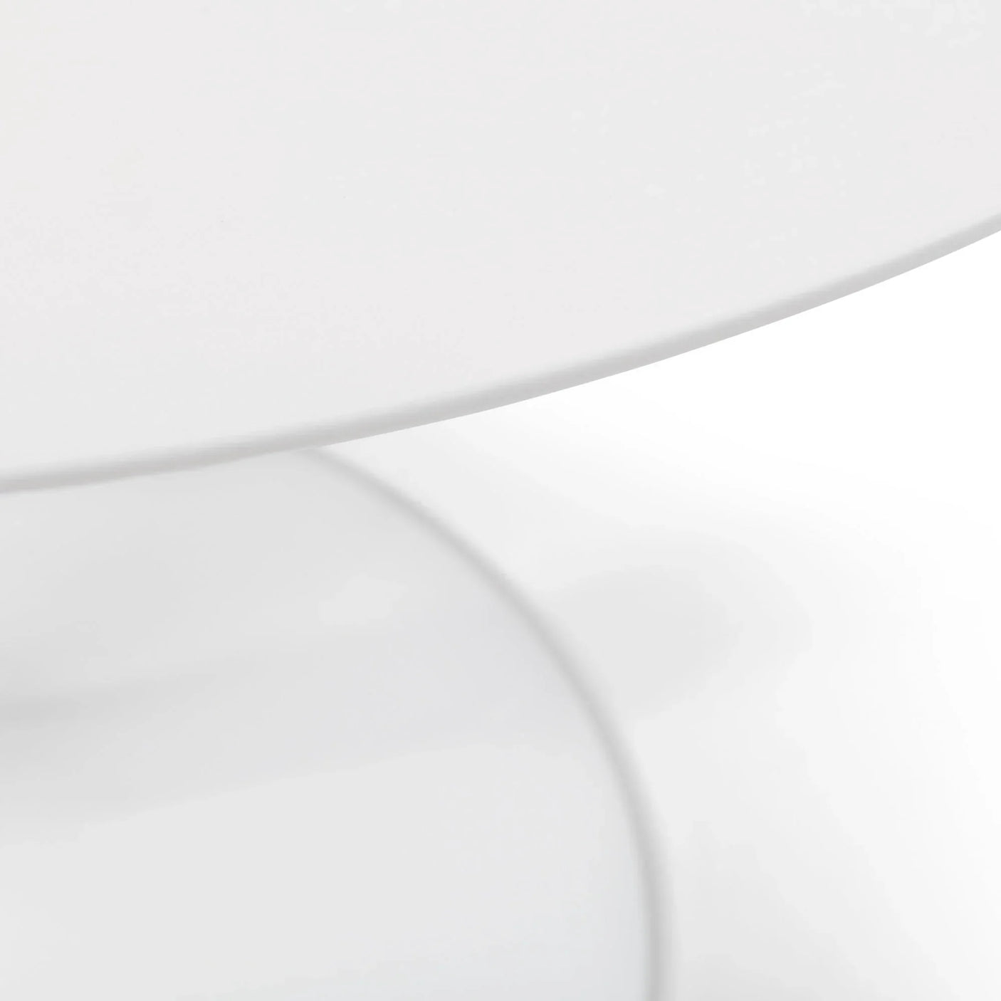 close view of round white table top and base for modern dining room furniture