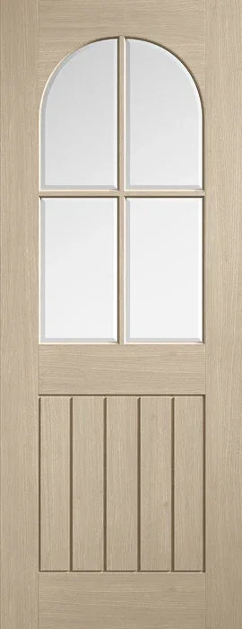 Blonde oak Mexicano door with arched square top glazed panels and vertical grooves