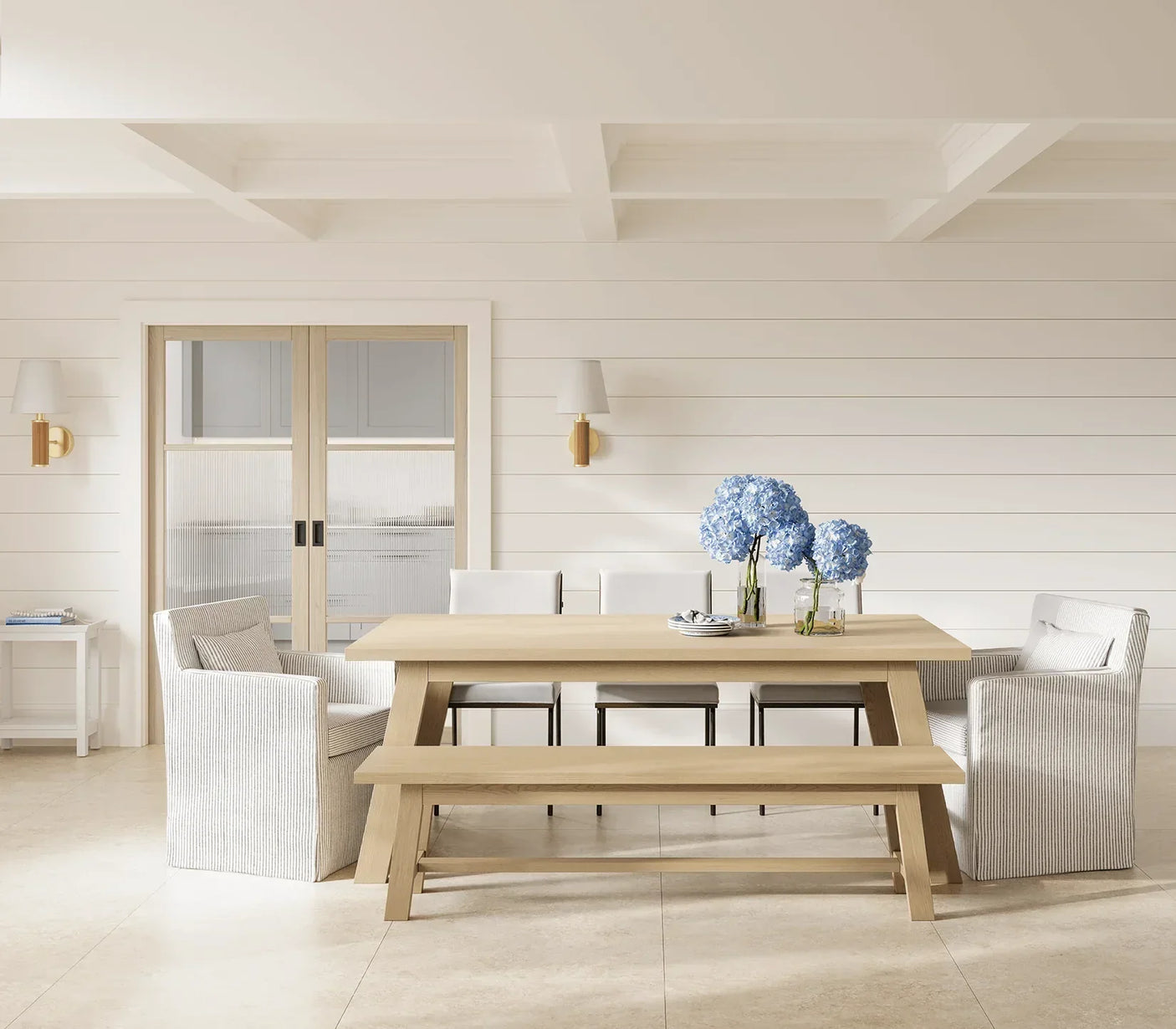 Blonde oak Sutton reeded glazed dining table with bench, armchairs, and blue hydrangeas