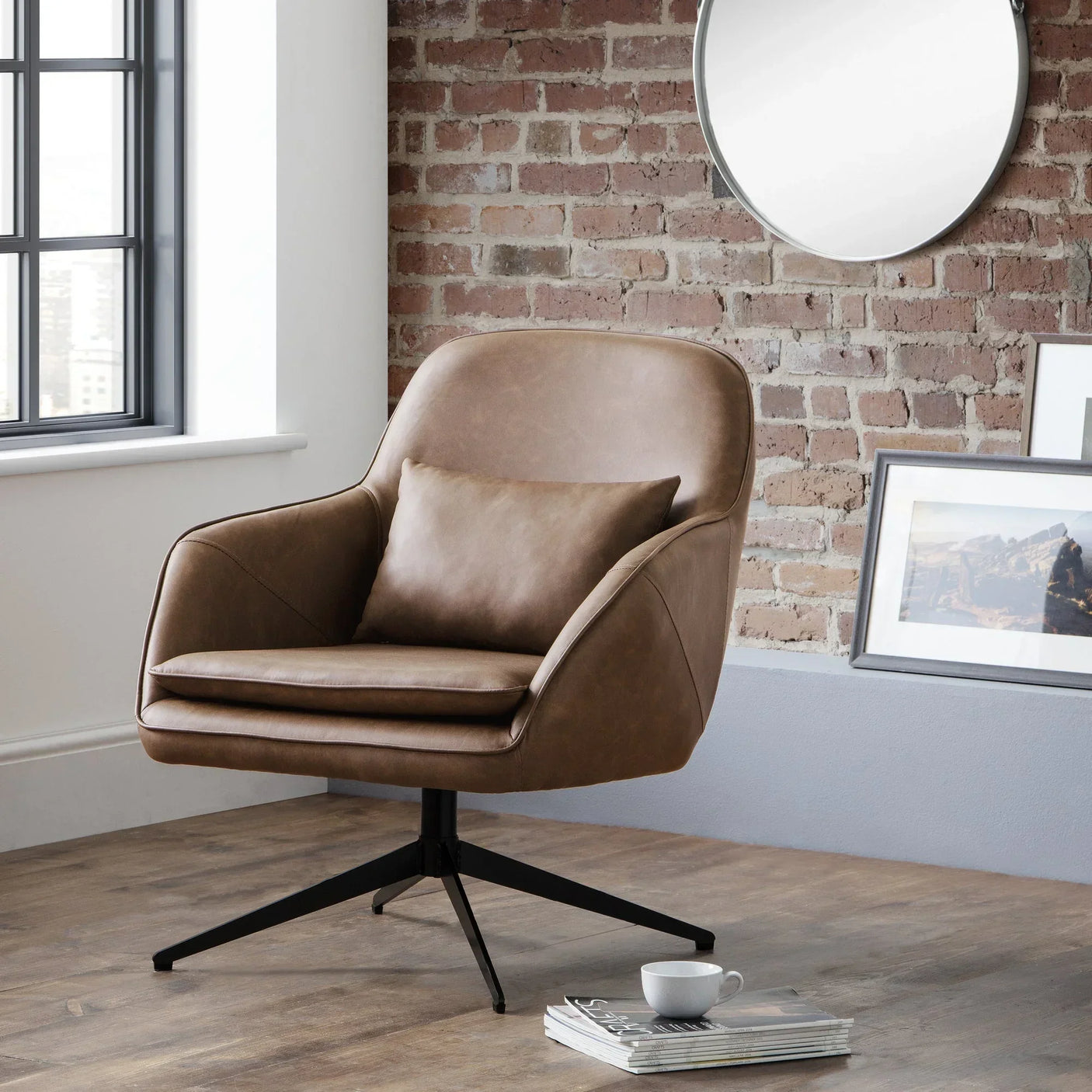 Brown leather swivel chair with cushion in modern living room with brick wall