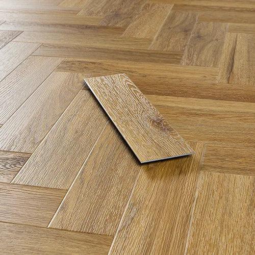 Brushed oak wood flooring tile sample on herringbone laminate floor