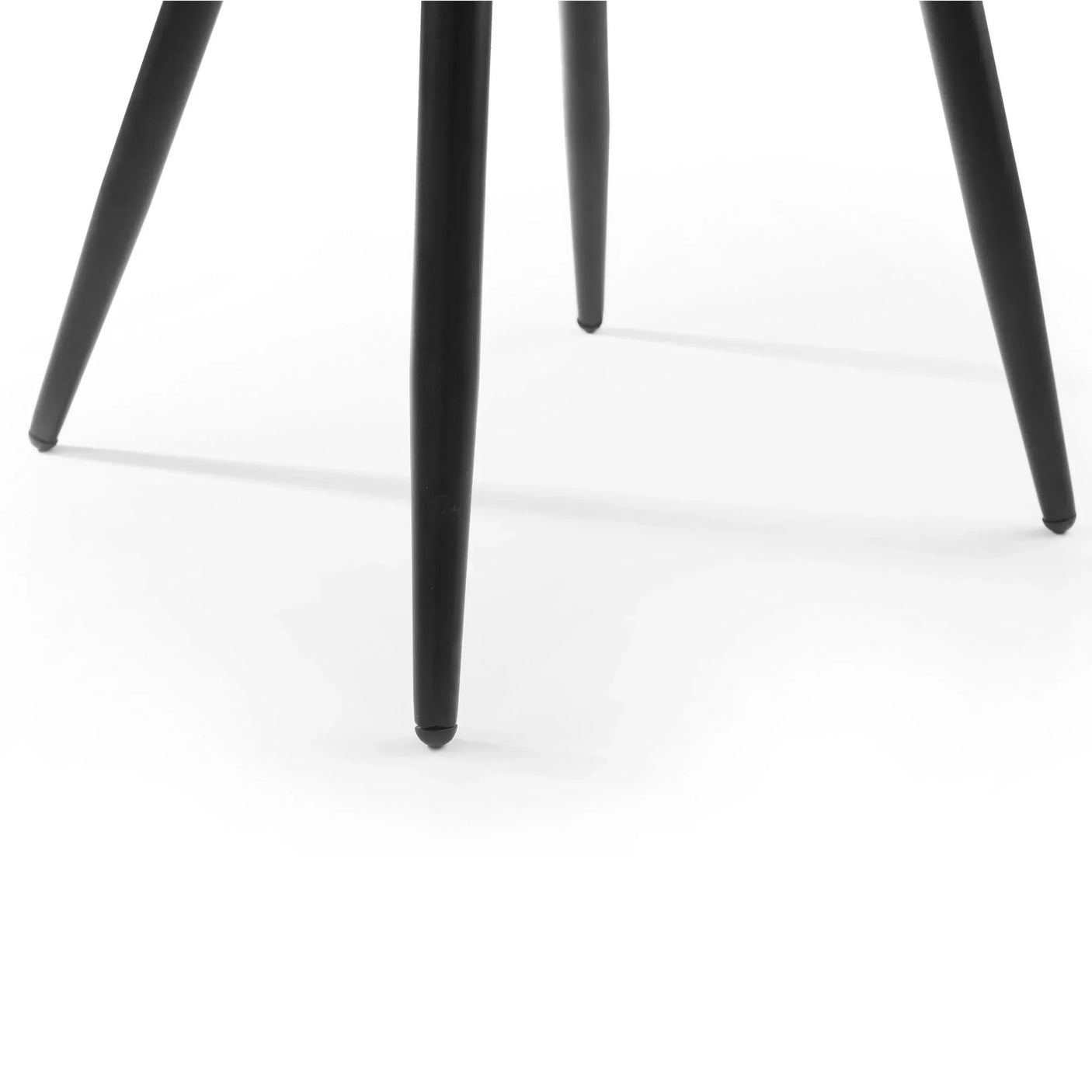 Close detail of black metal chair legs on white background