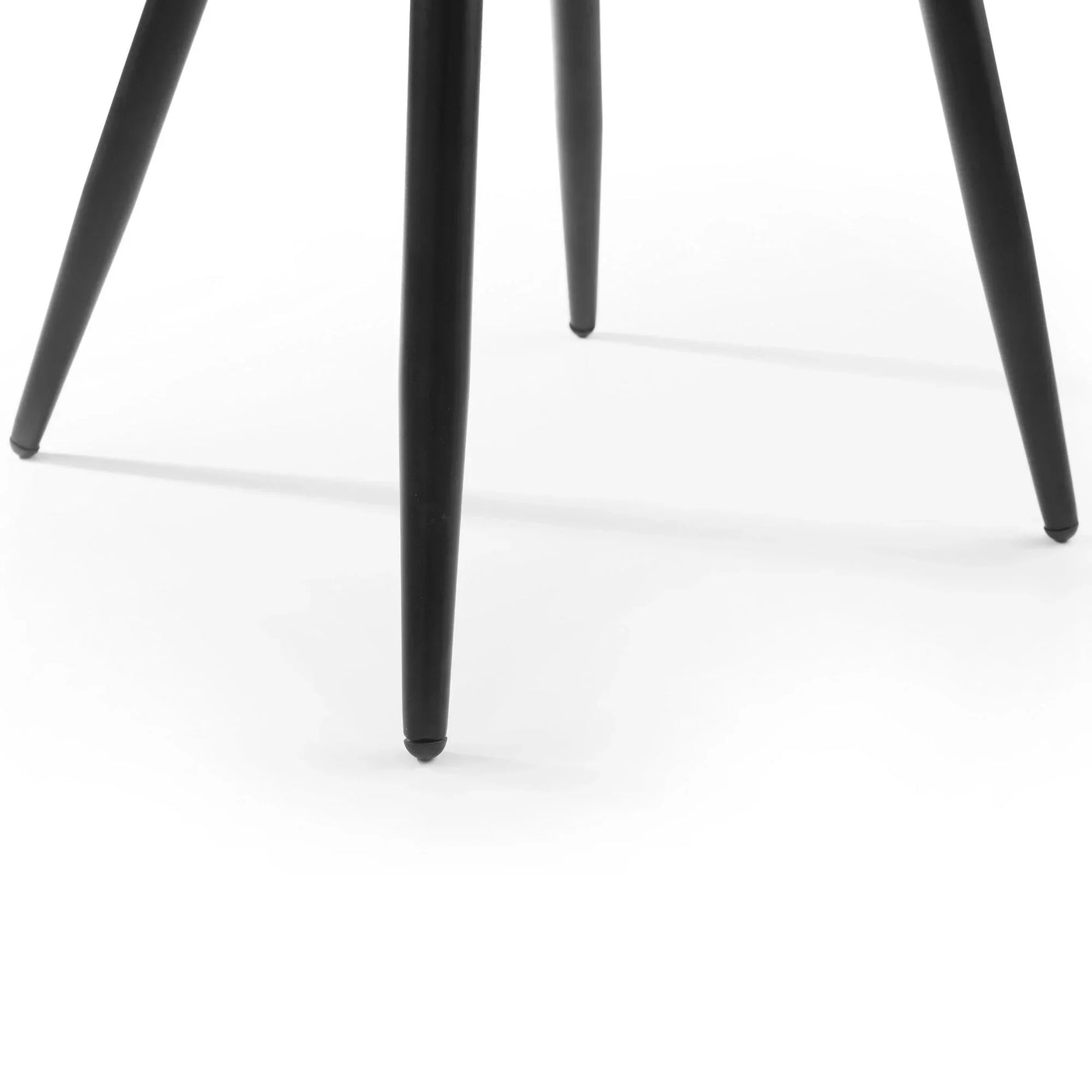 Grey chair black tapered legs close-up on white background