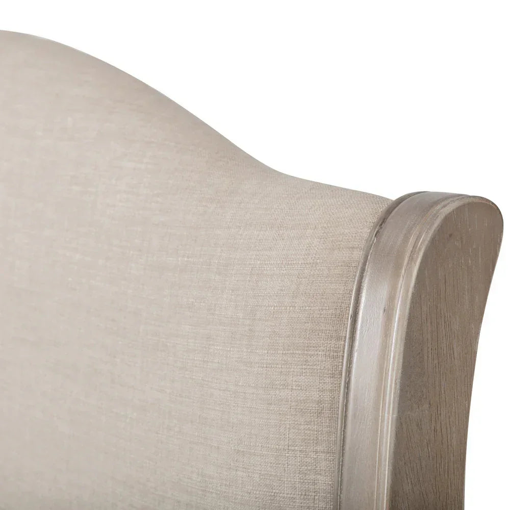 fabric upholstered double bed headboard with light wood trim close-up