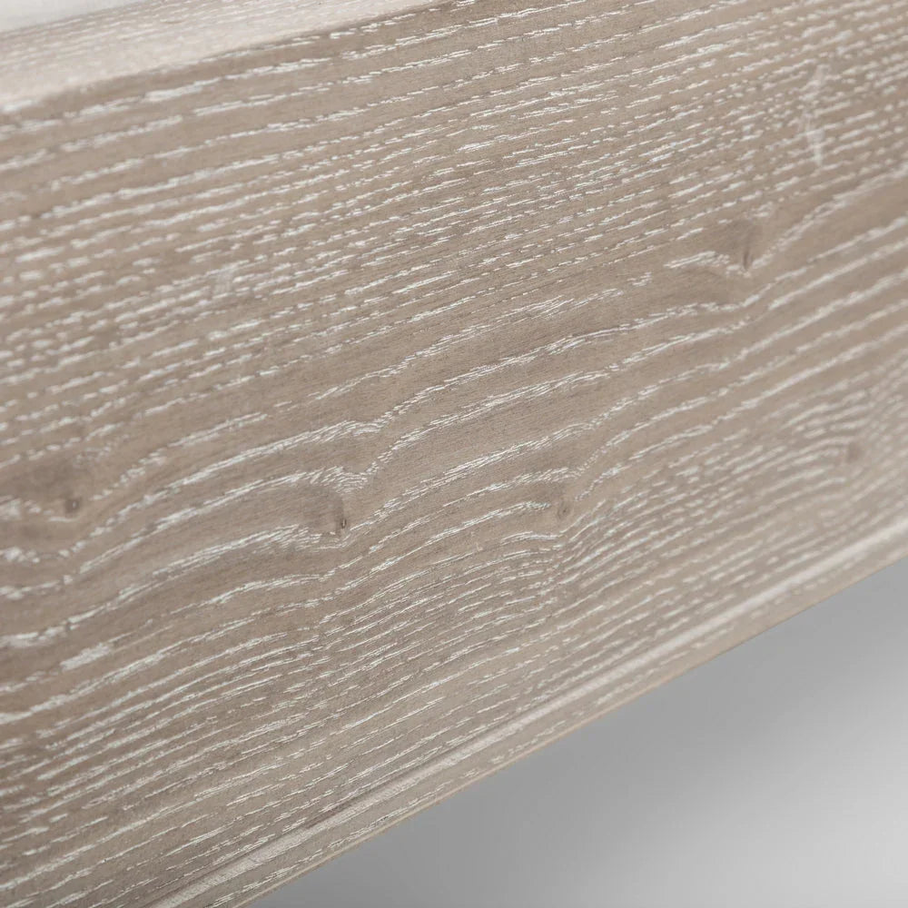 Close-up of double bed frame with light oak wood grain finish