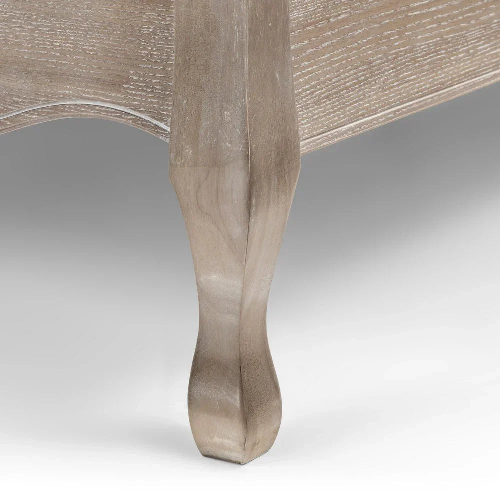 Close-up of wooden Camille double bed leg with carved detail and natural grain finish