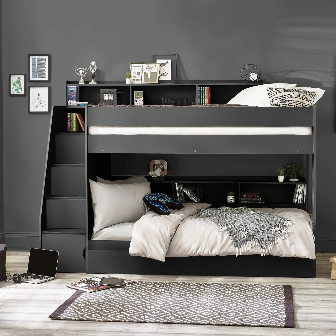 Anthracite staircase bunk bed with storage shelves and bedding in modern grey bedroom