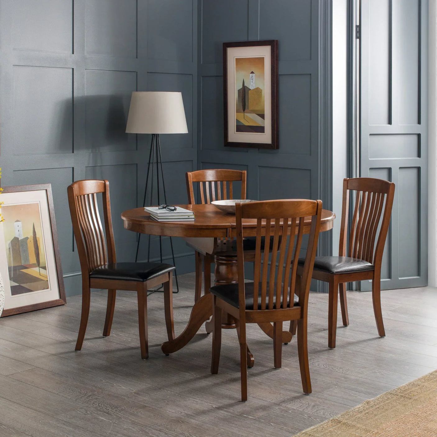 Round wooden dining table with four matching chairs in modern dining room