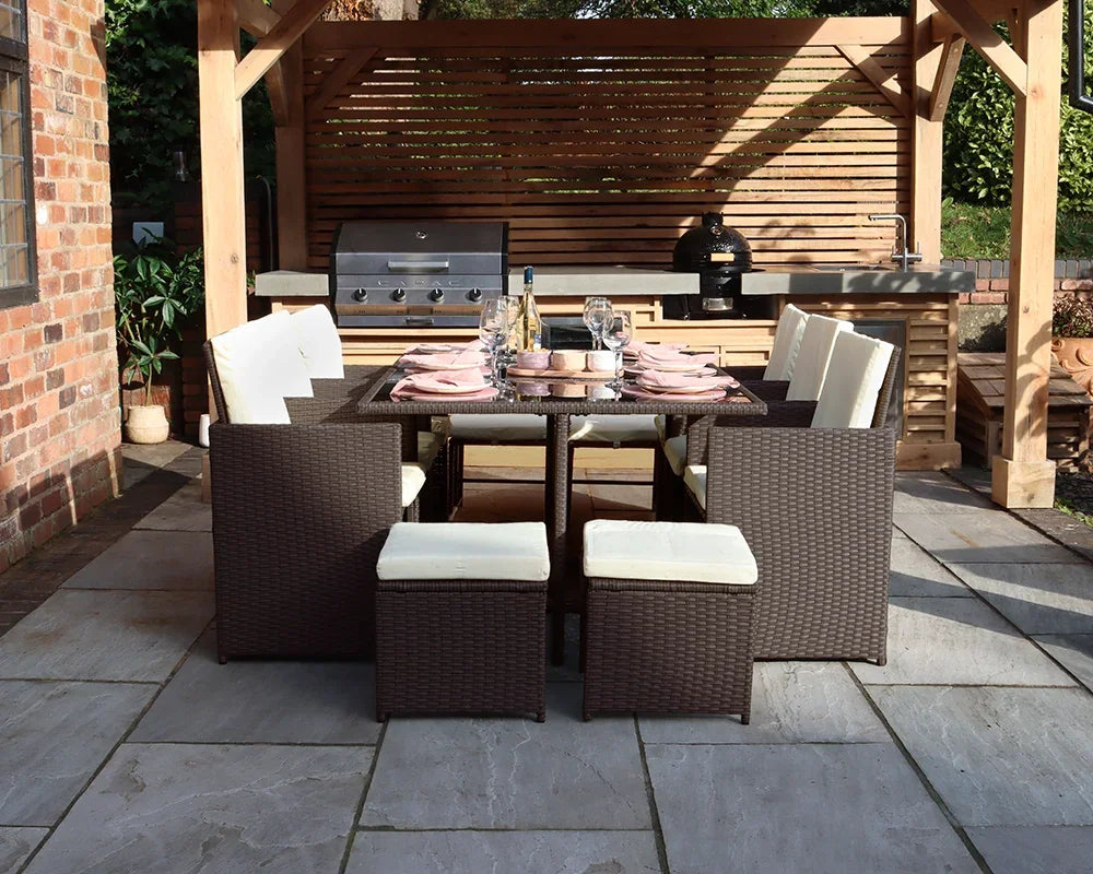 Brown rattan garden dining set with cream cushions arranged under wooden pergola