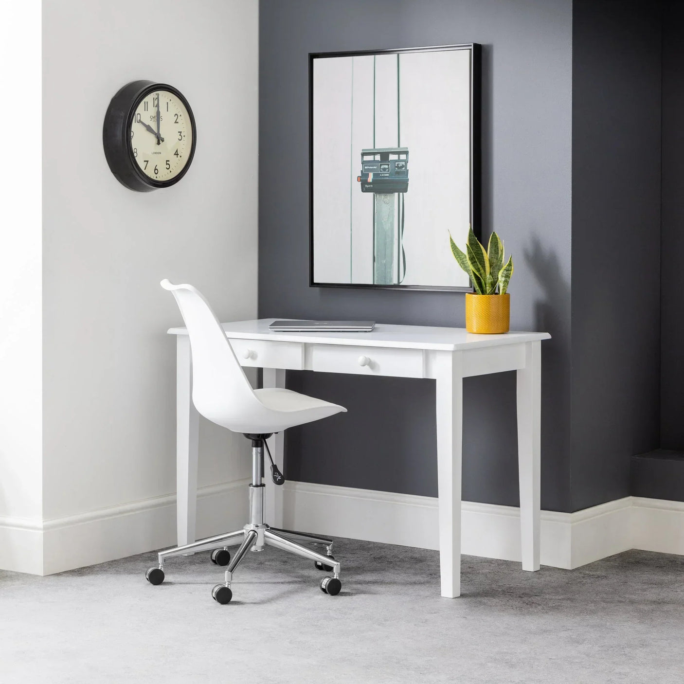 White desk with two drawers in modern study corner, white chair and plant on desktop