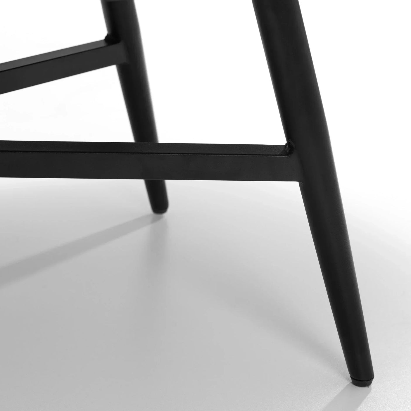 Black metal chair legs with cross supports on white background