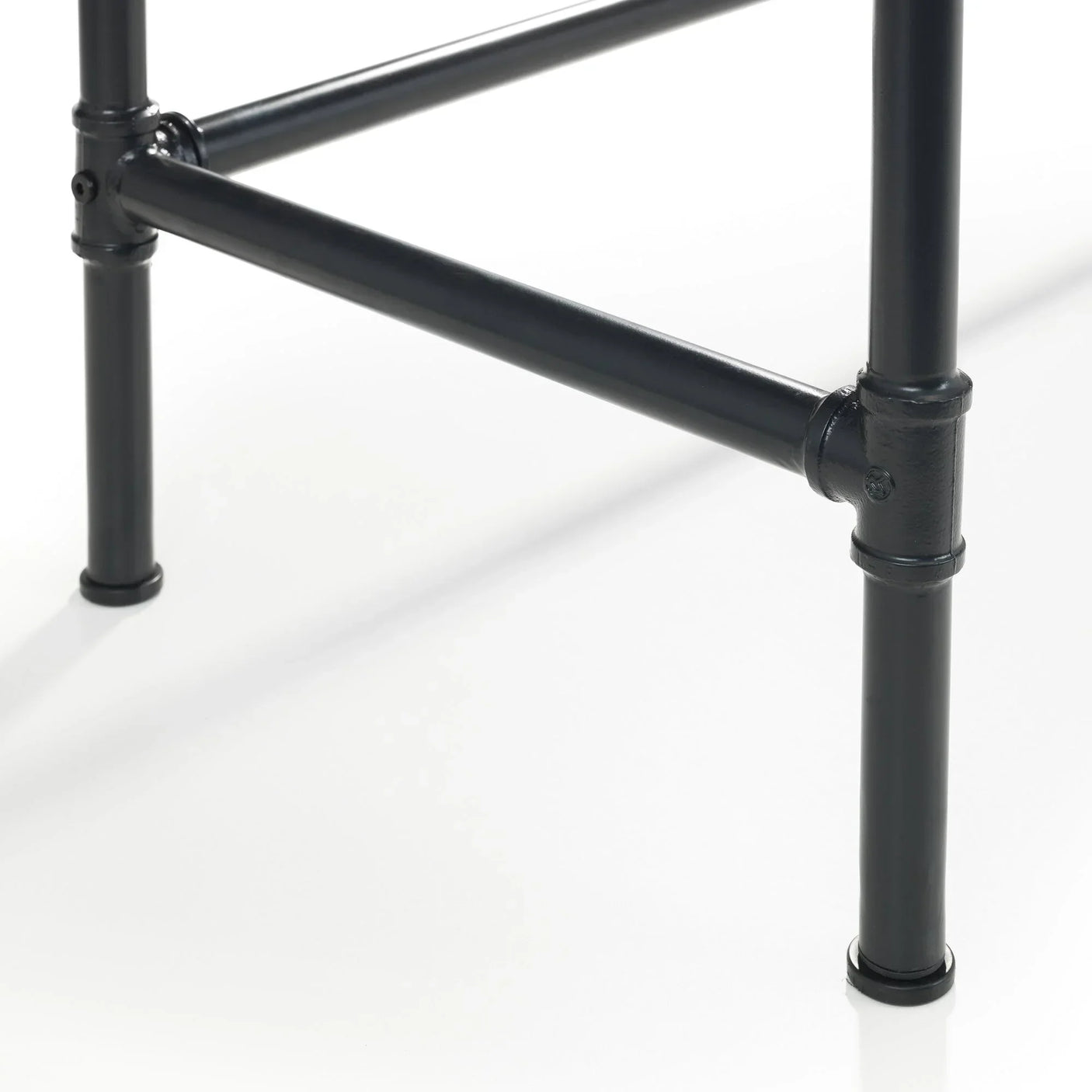 Black metal pipe desk frame with connector joints on white background
