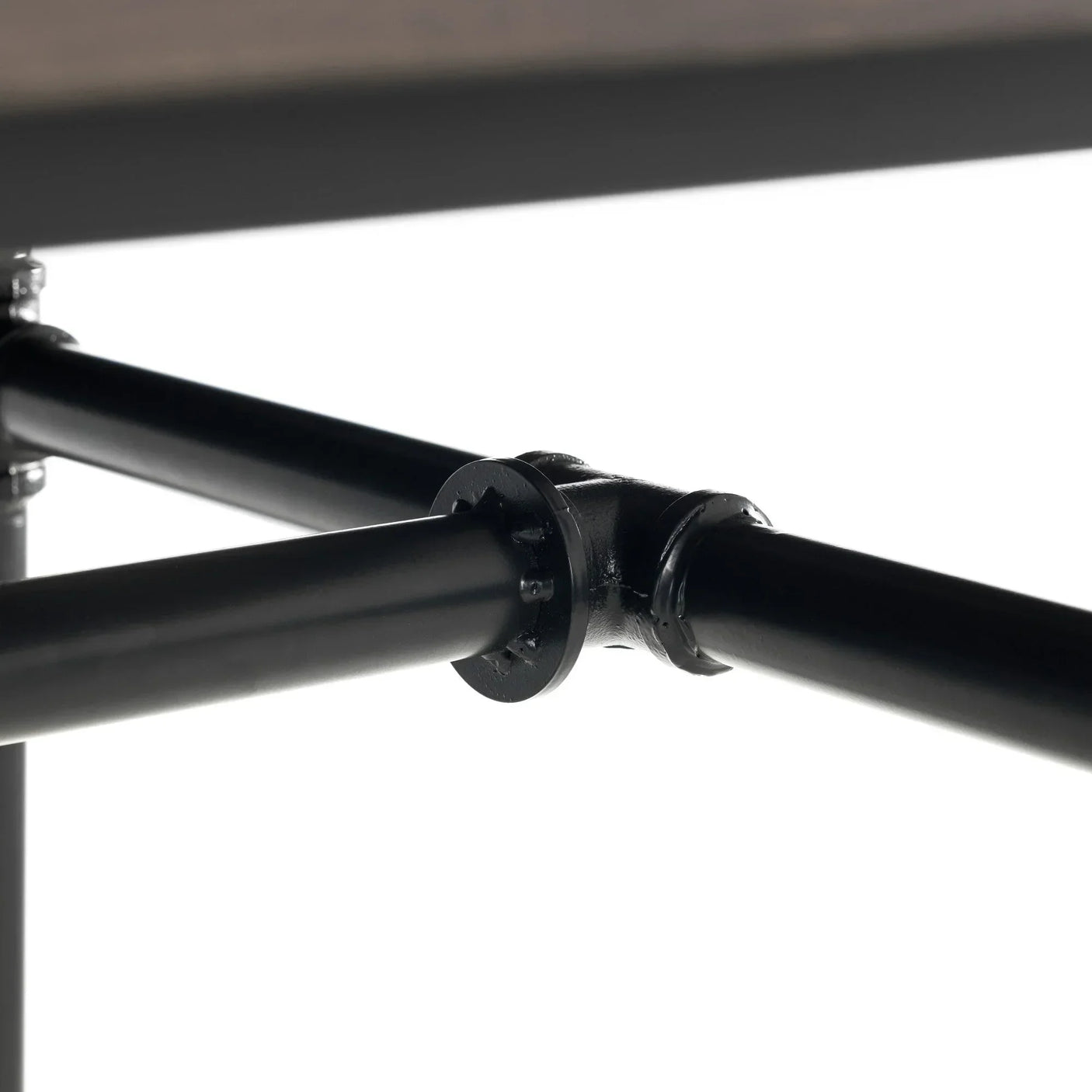 Black metal support frame detail under dining table