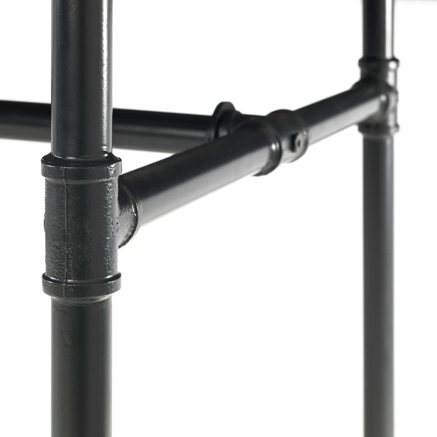 Black metal table leg frame with industrial pipe fittings close-up