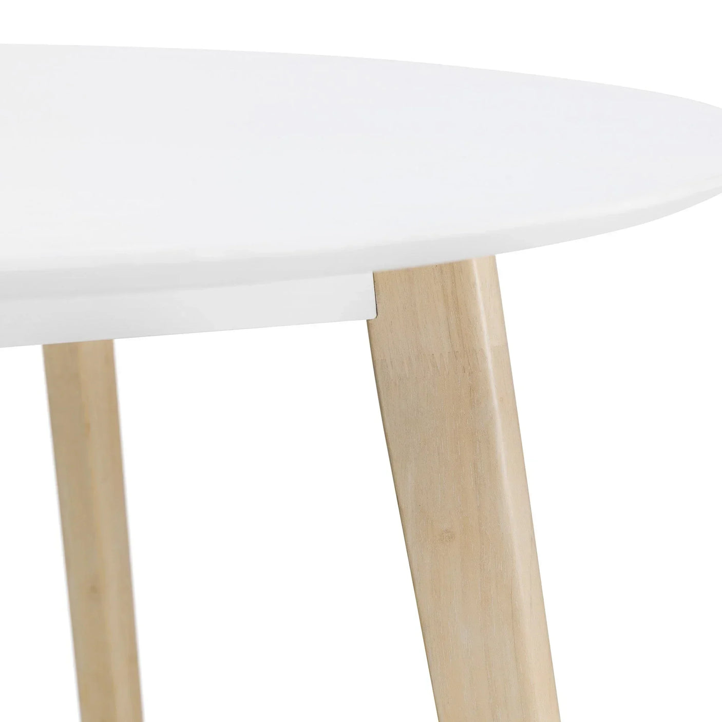 Closeup of white round table with natural wooden legs