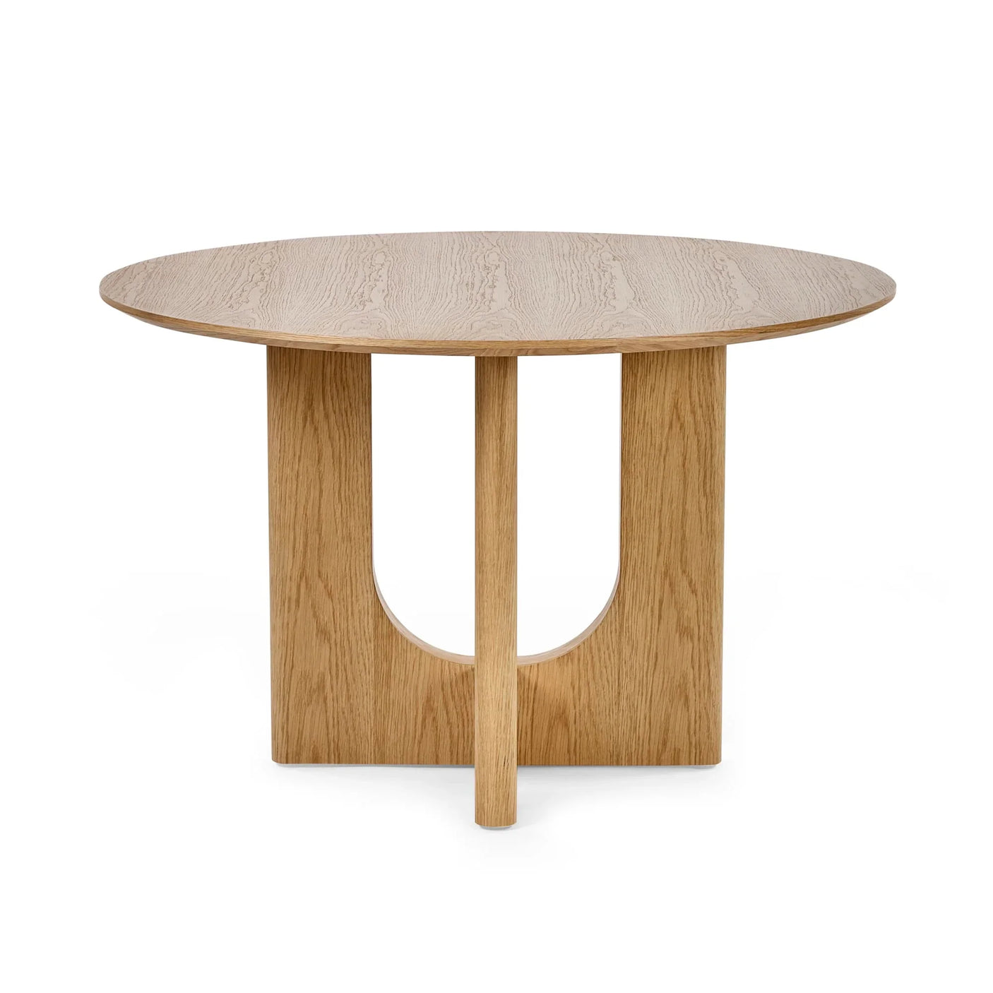 Round oak dining table with sculpted base on white background
