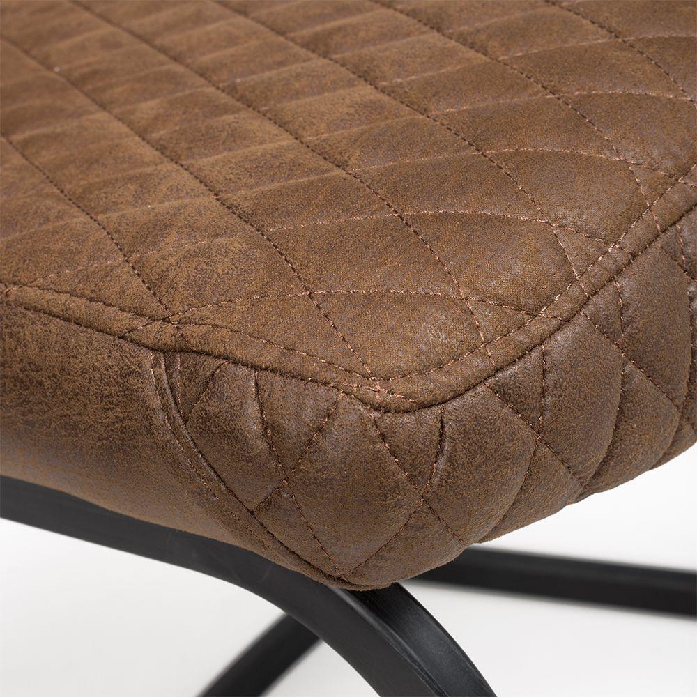 Close up of brown faux leather dining chair seat with quilted stitching and black metal legs