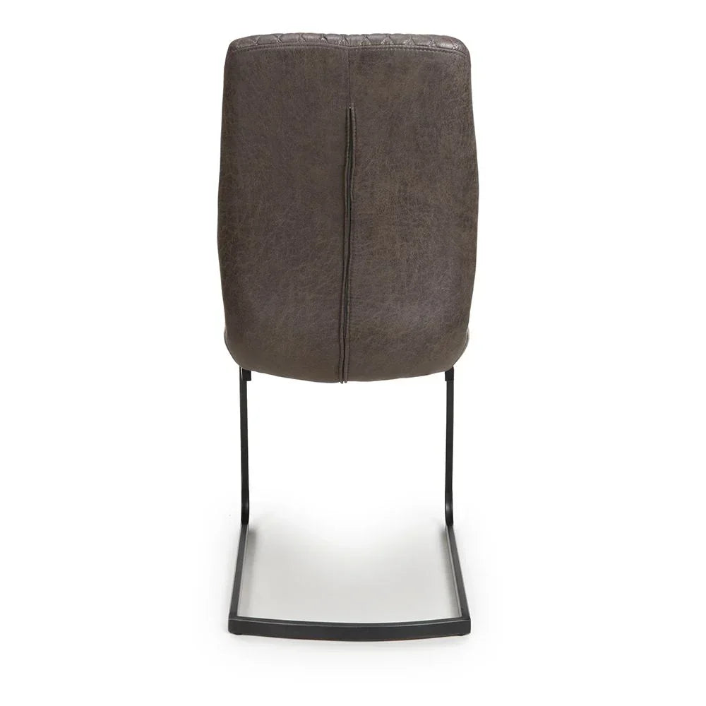 Rear view of brown faux leather dining chair with black metal cantilever base
