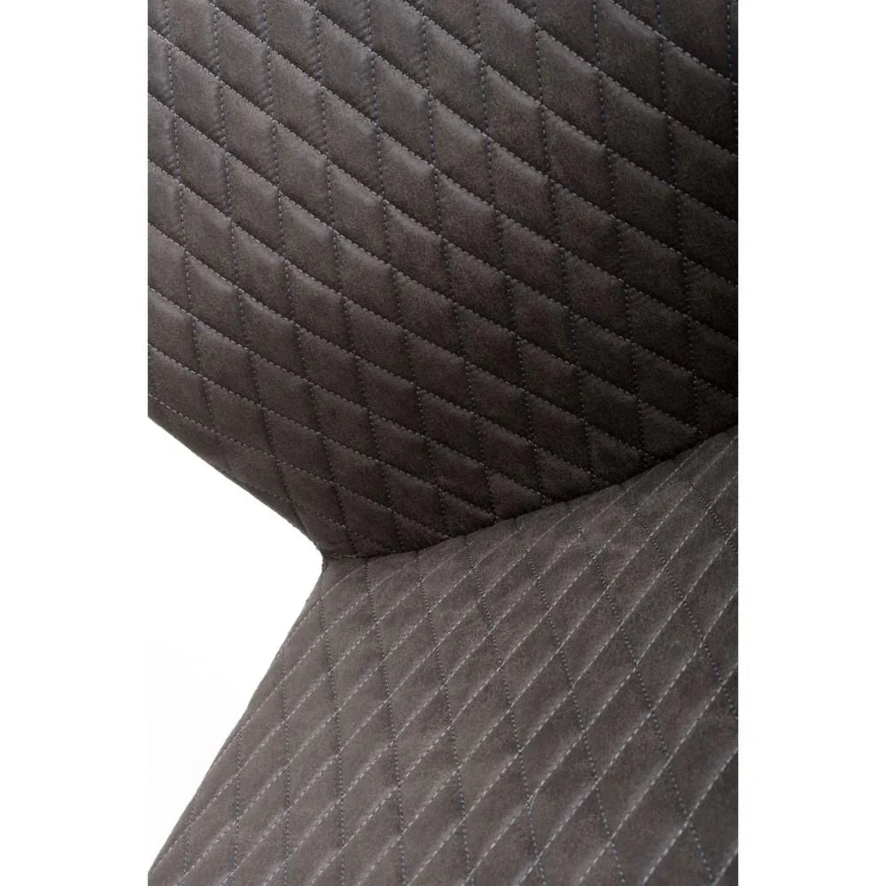 Grey dining chair with diamond quilted upholstery, close up of cushioned seat and back