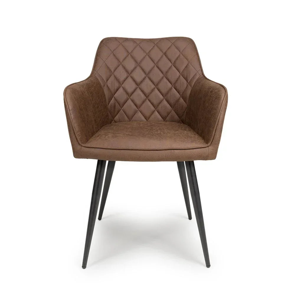 Brown dining chair with diamond-quilted backrest and black metal legs, front facing view