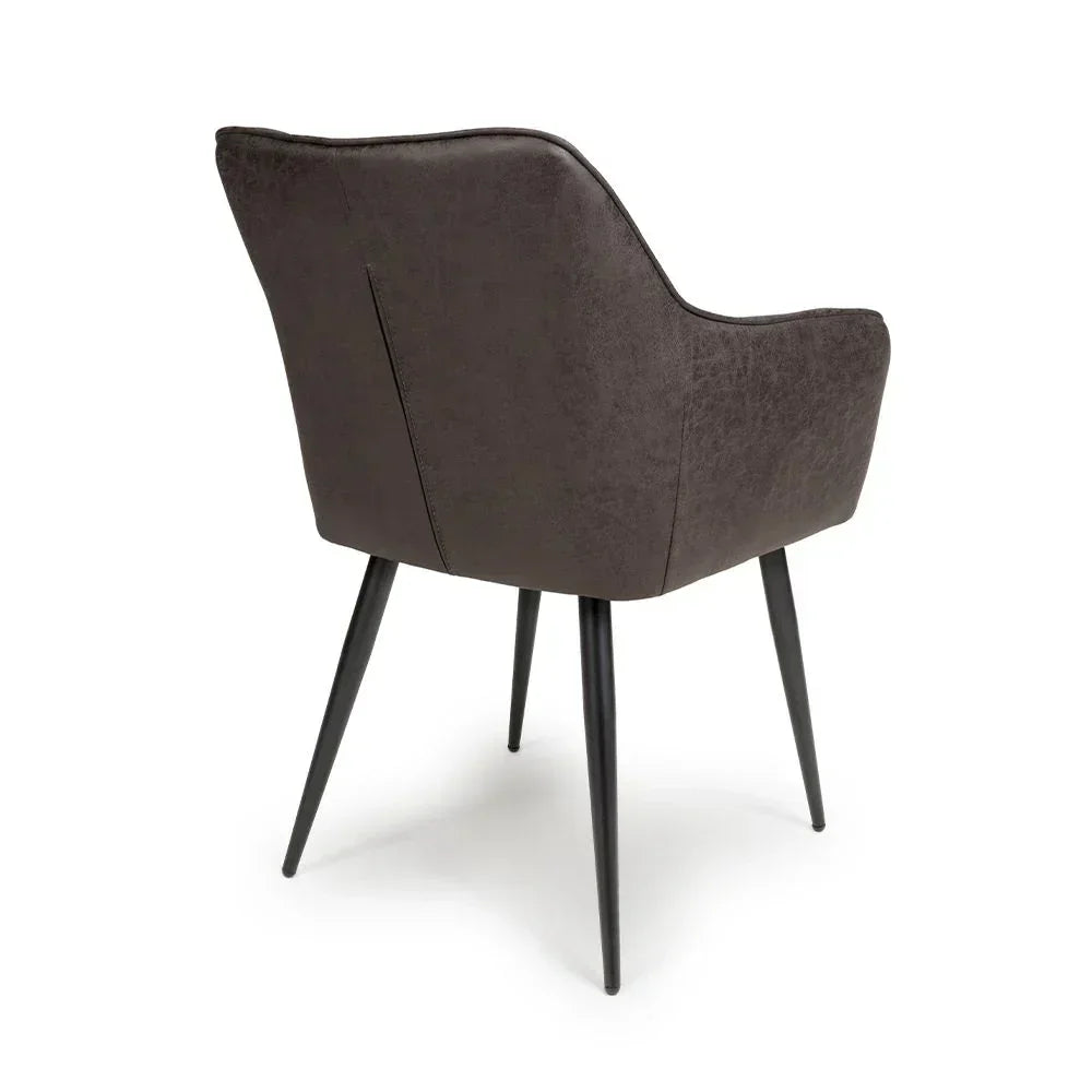 Back view of grey dining chair with black metal legs and curved upholstered seat