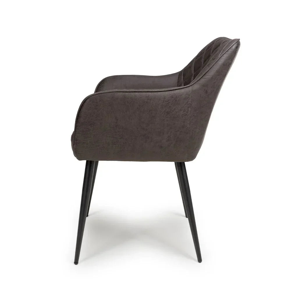 Side view of grey dining chair with upholstered seat, angled black metal legs