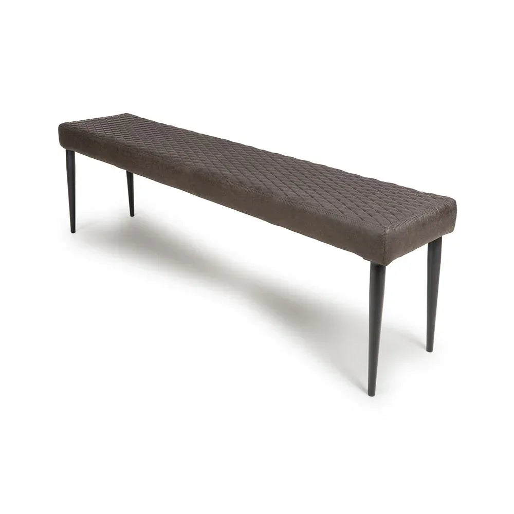 Brown upholstered dining bench with quilted seat and black tapered legs on white background