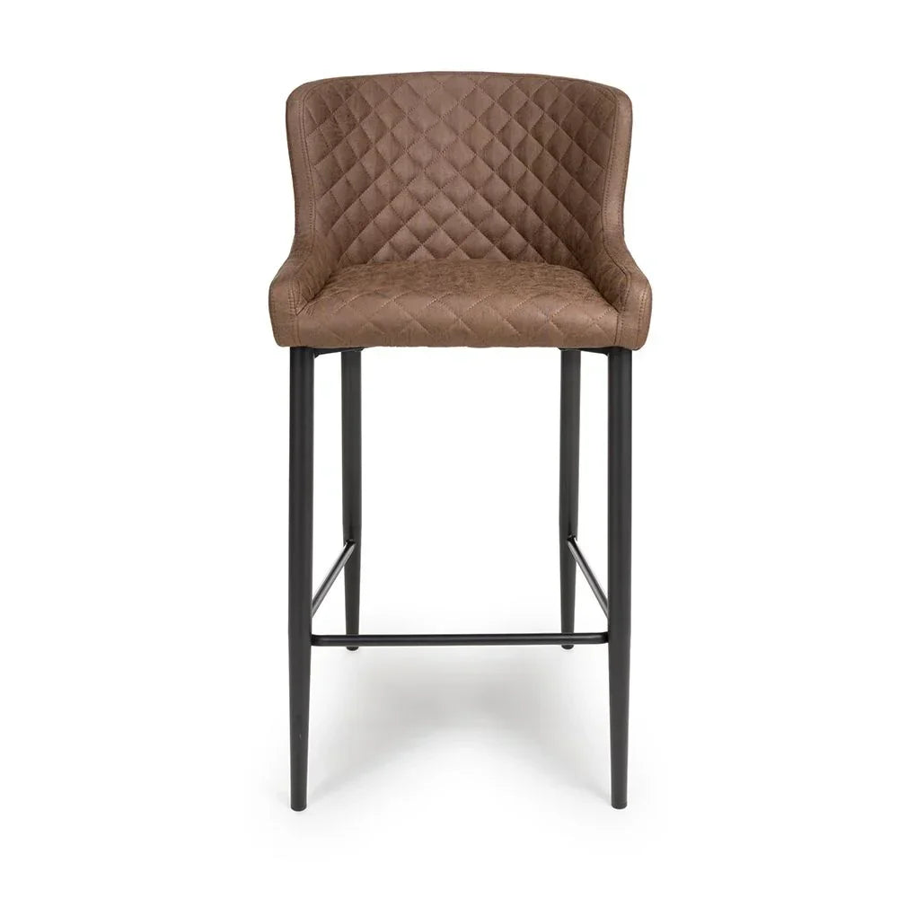 Brown bar stool with quilted backrest and black metal legs, front view