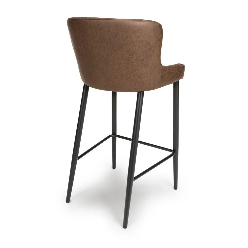 Brown faux leather bar stool with black metal legs, shown from back angle