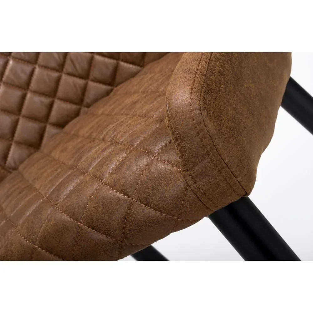 Brown faux leather dining chair with quilted stitching and black metal legs closeup