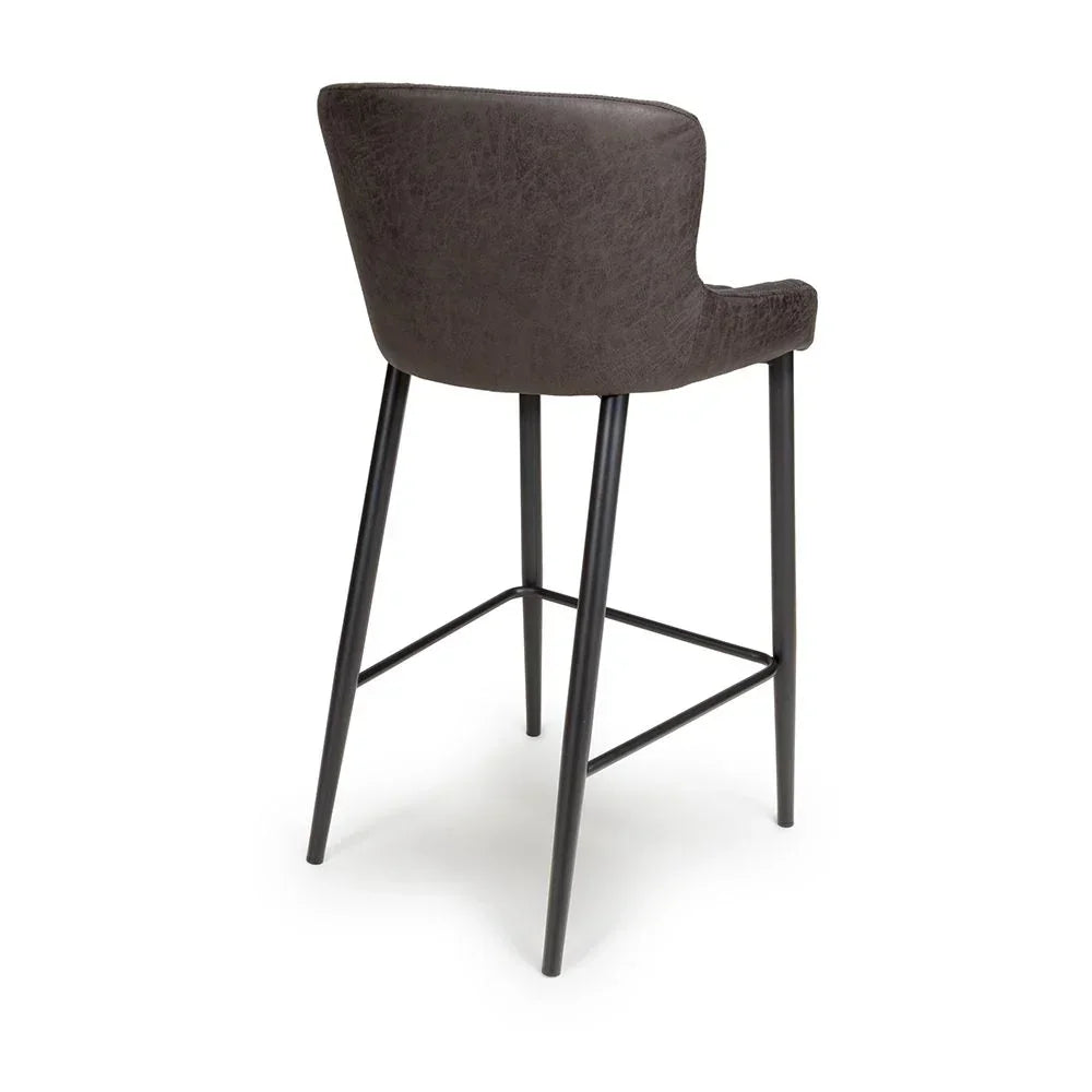 Back view of brown bar stool with curved seat and black metal legs
