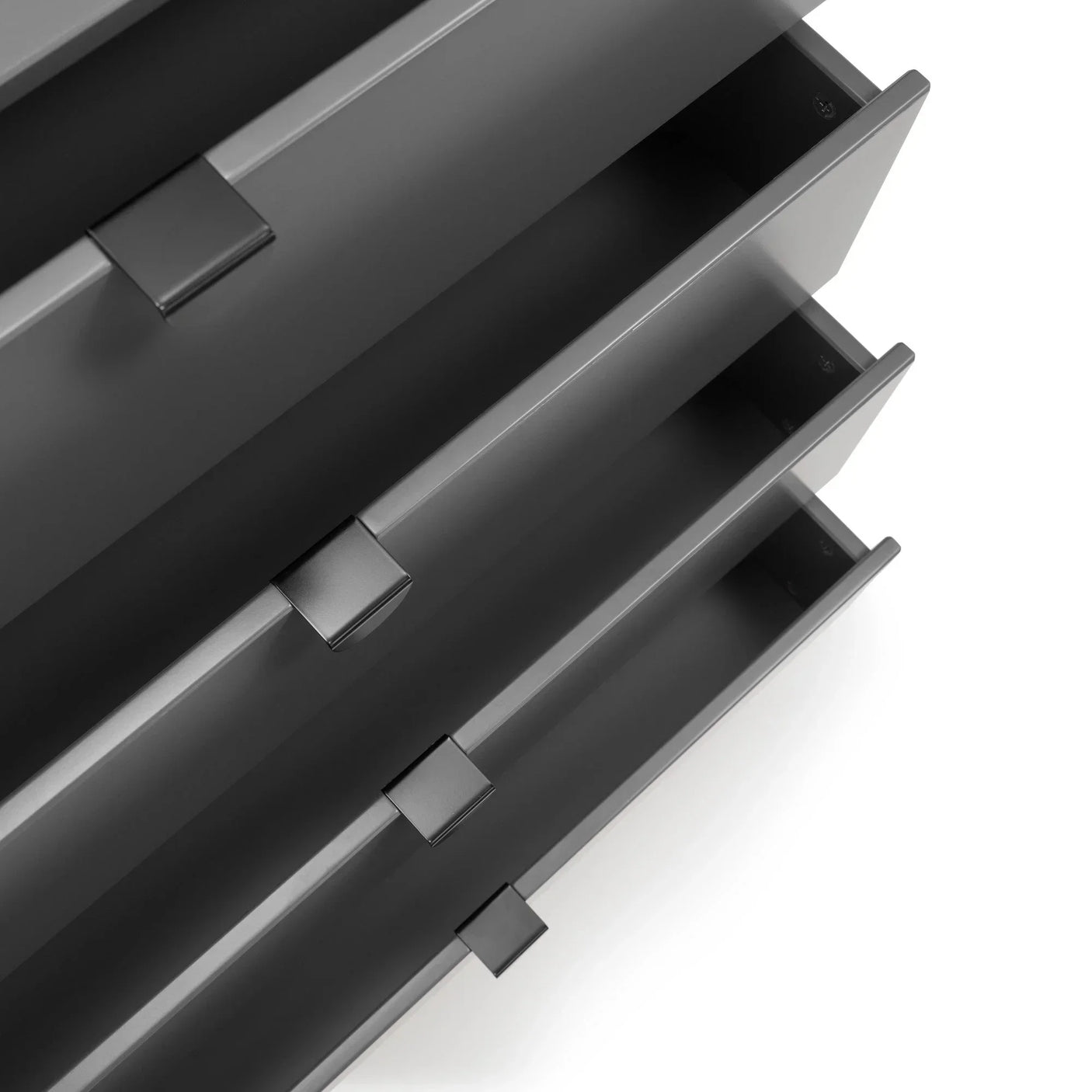 Close-up of black metal drawer handles and sleek linear cabinet design